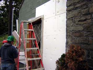 EIFS insulation boards being fastened to a substrate consisting of an existing CMU wall