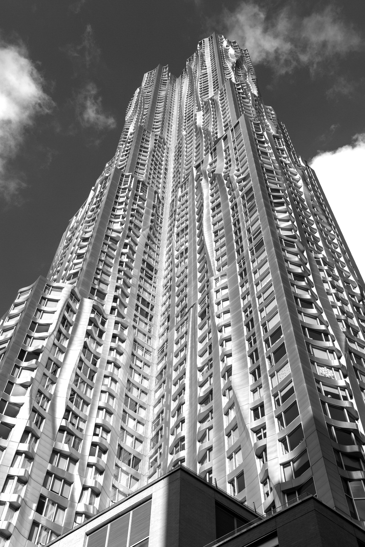 Image of gehry-designed building with shimmering and curved stainless-steel panels as exterior cladding.