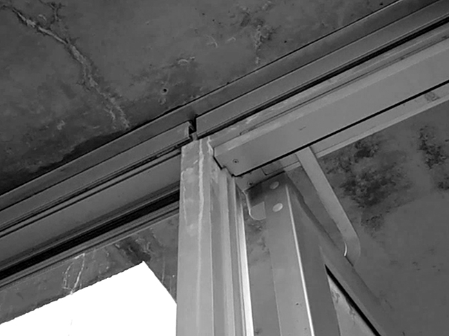 Looking up at gallery ceiling at curtain wall.