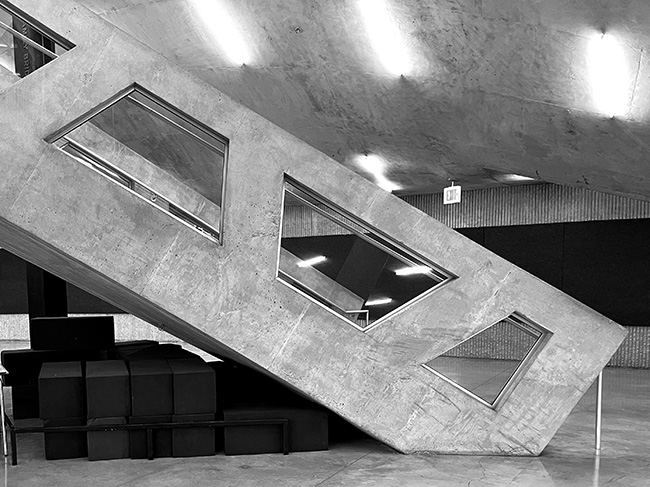 Photo of Crit Room stair with combustible plastic stands beneath it.