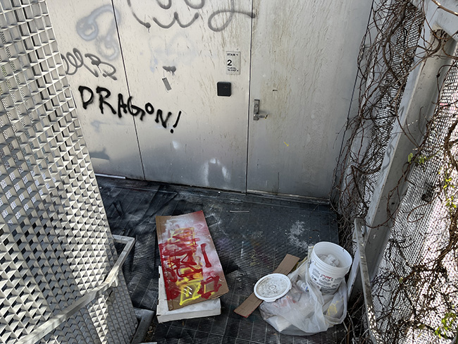 Graffiti and debris litter Milstein Hall's exterior egress stair.