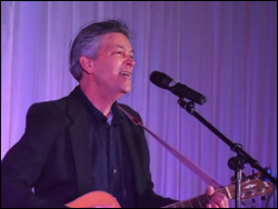 Jonathan Ochshorn with guitar performing in Tianjin, China