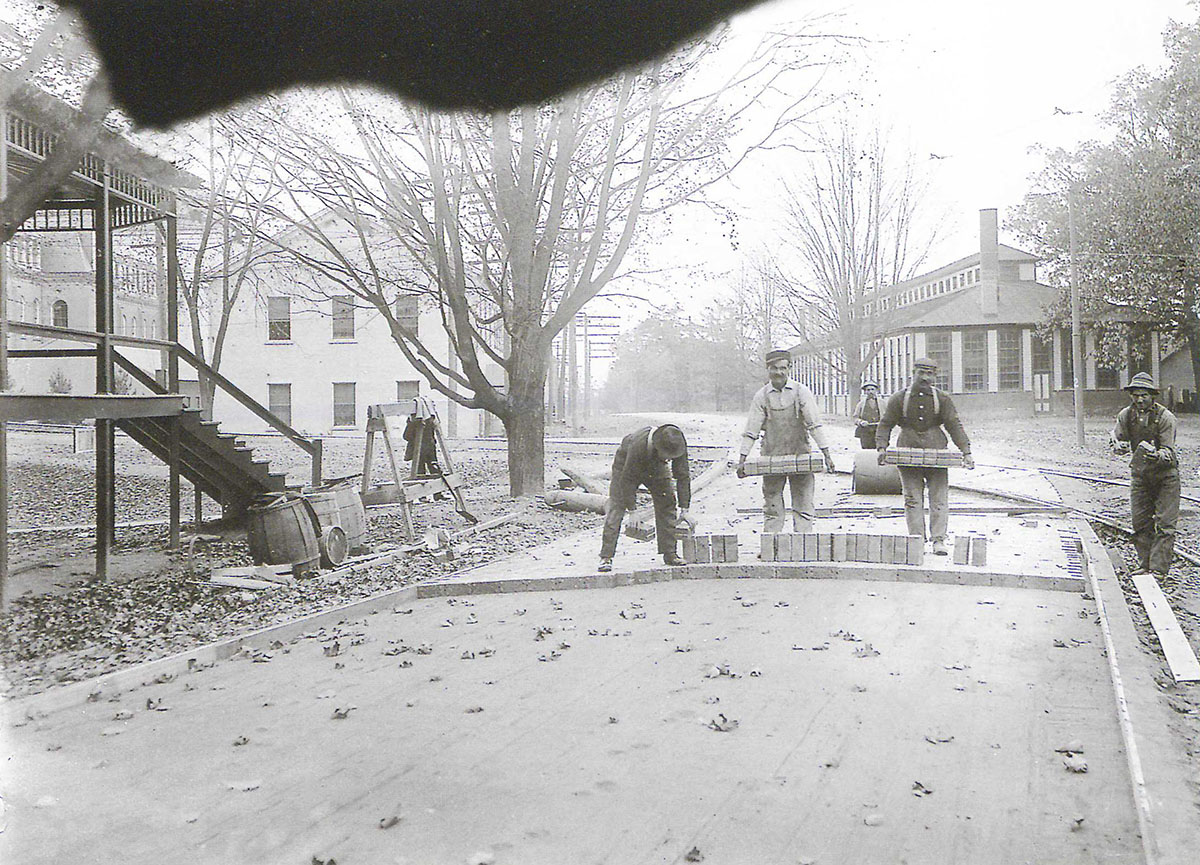 1909 photo showing University Avenue and including the forge shop and foundry placed north of the Sibley College of Mechanical Engineering and Mechanical Arts at Cornell University